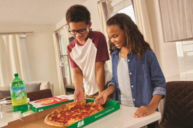 Kids standing and eating Marco's Pizza