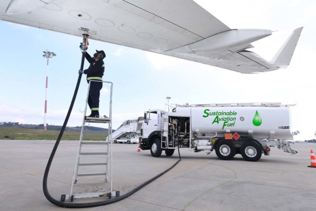Technician is refueling aircraft with SAF at the airport