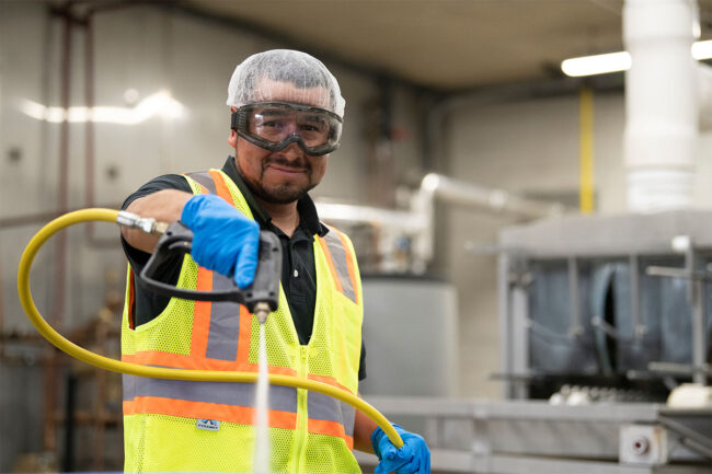 Worker sprays water for cleaning