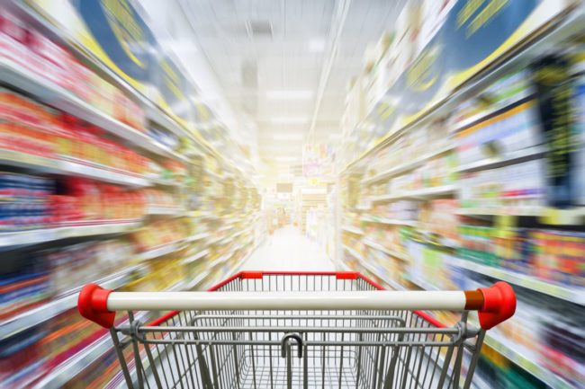 Shopping cart in grocery store aisle