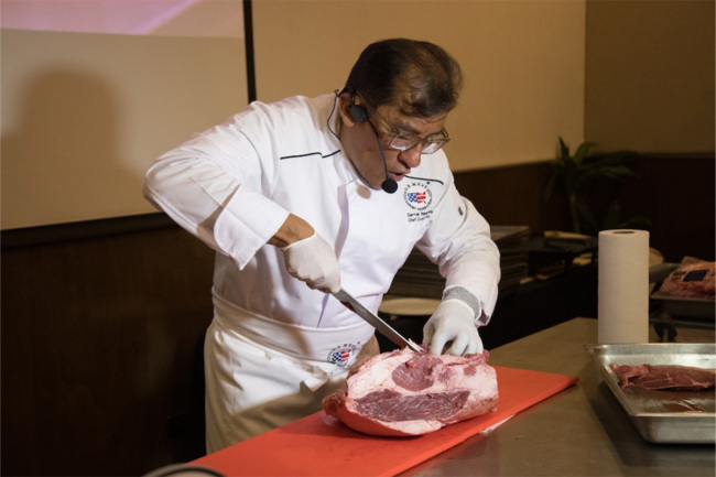 German Navarette demonstrates handling US pork product