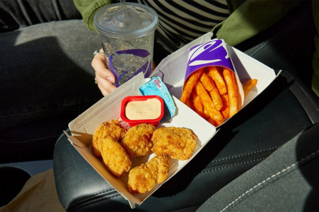 Taco Bell chicken nuggets with dipping sauce and fries