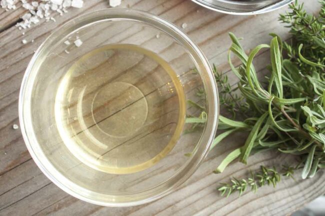 bowl of vinegar and sprigs of fresh rosemary.jpg